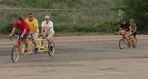 kids on a tandem chase the quad